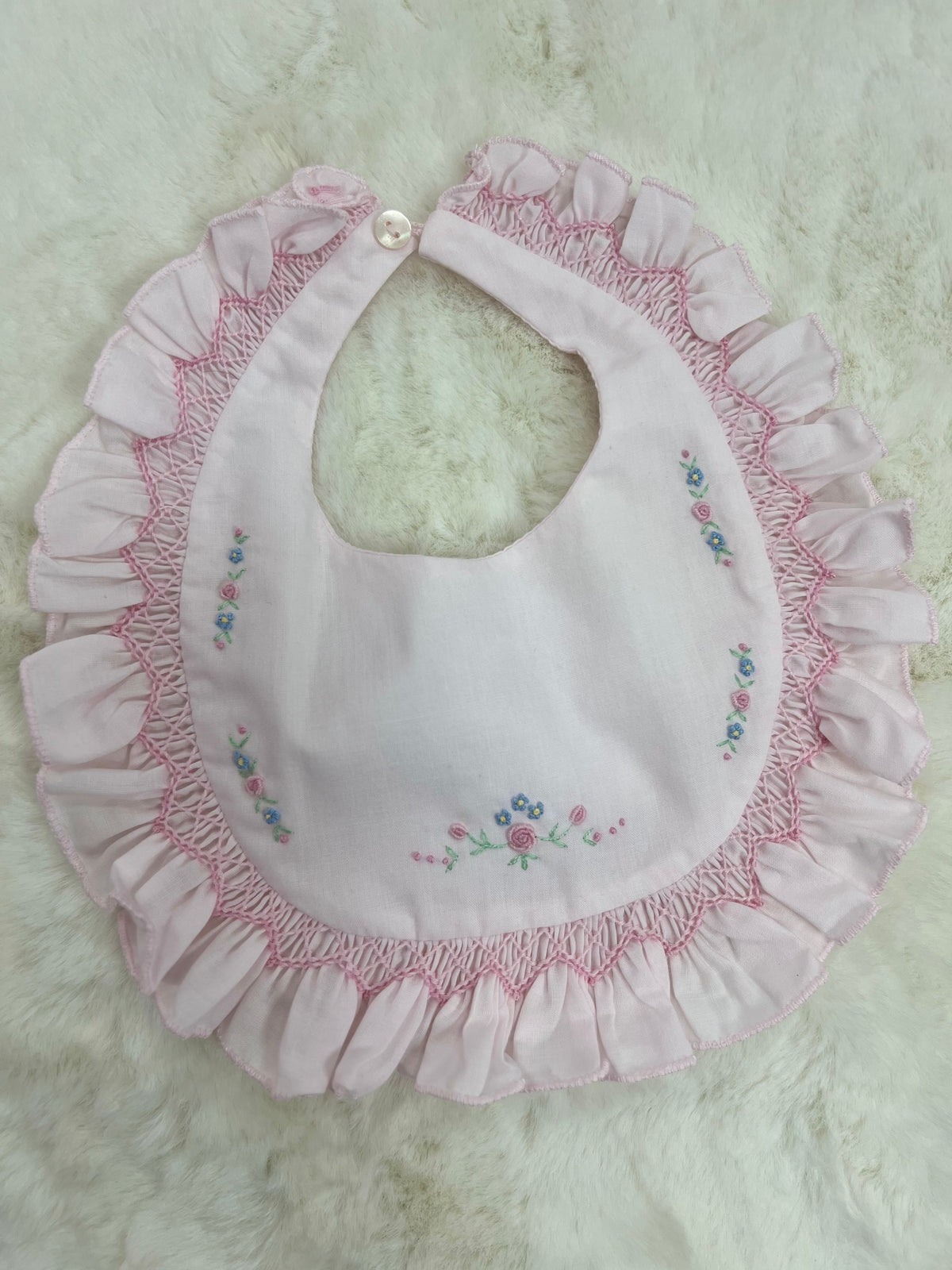 Pink smocked floral bib